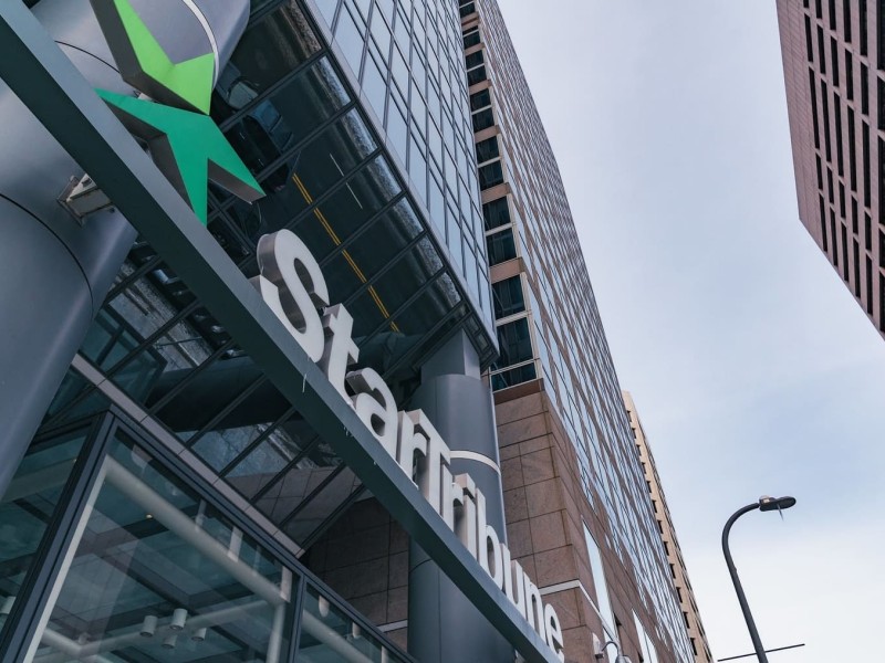 A photo of the Star Tribune office angled toward the logo.