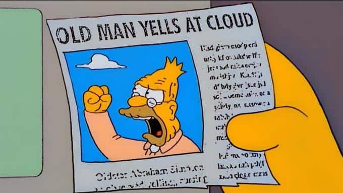 A close-up of a newspaper where a grizzled Homer Simpson is the lead photo, with the hed saying "Old Man Yells at Cloud"