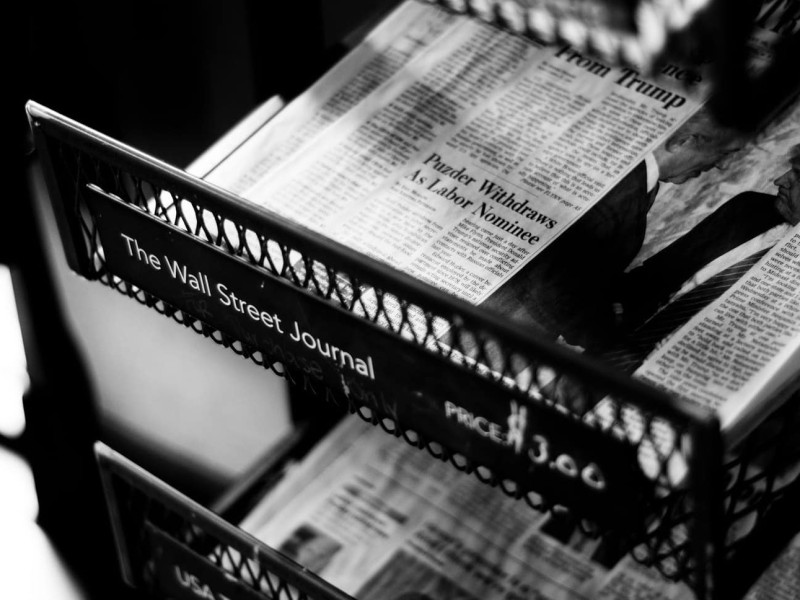 A close-up of a half-empty Wall Street Journal newsstand.
