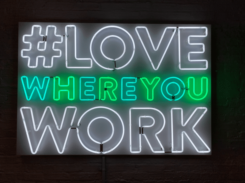 A neon sign that says #LoveWhereYouWork