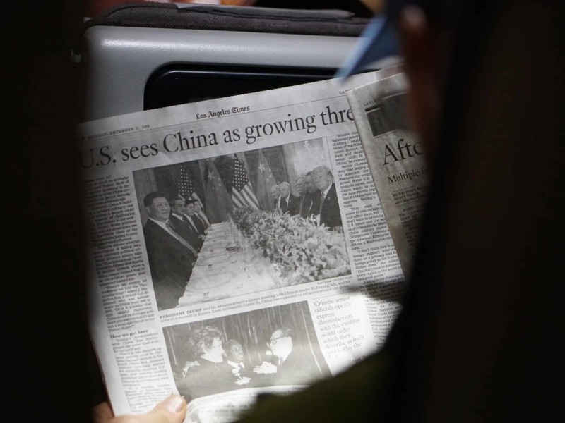 Person holding a newspaper.
