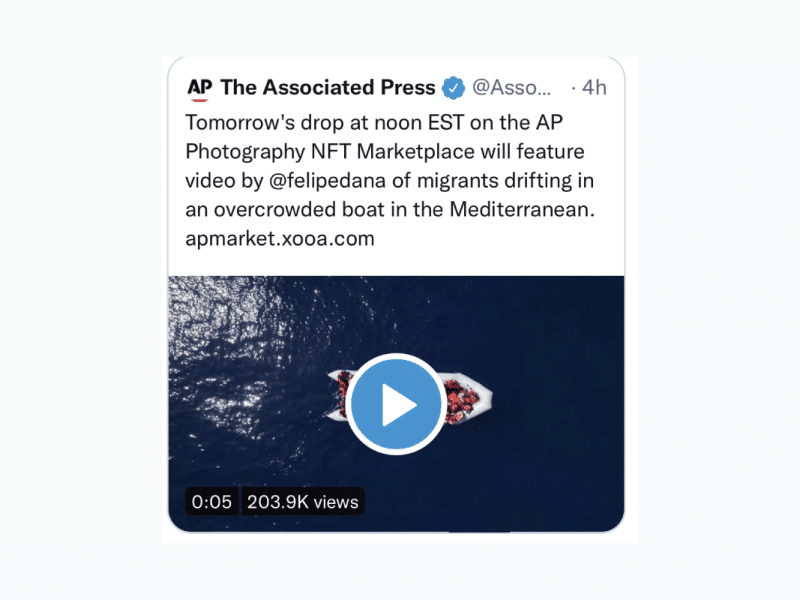 A screenshot of the AP's tweet announcing the NFT sale of a photo showing migrants crossing an ocean.