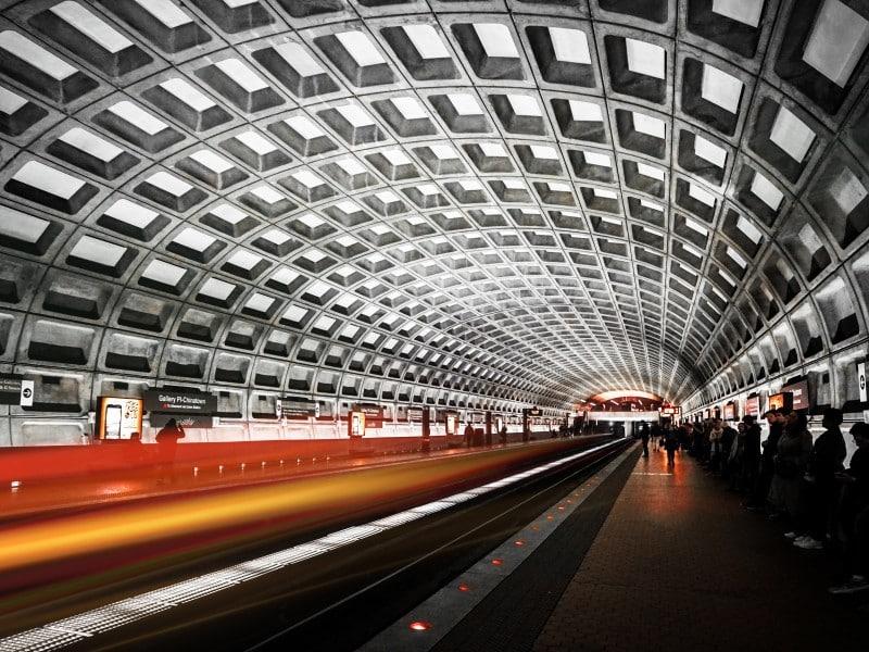A long exposure photograph of a DC metro train pulling through the Gallery Place station.