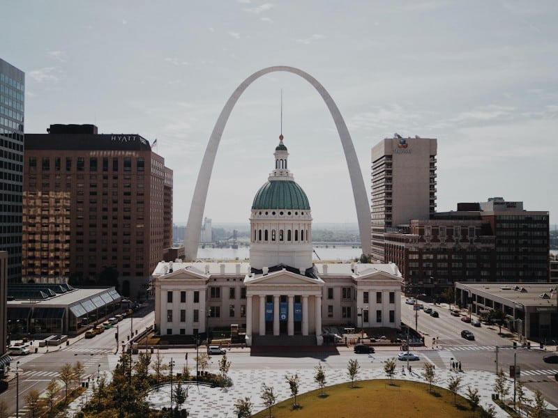 Photo of the St. Louis waterfront. The Arch and Mississippi river are in the background.