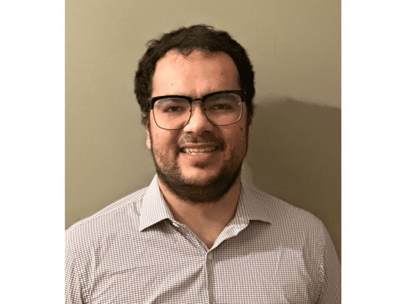Headshot of Nawar Nemeh. He wears a button up shirt and half rim glasses.