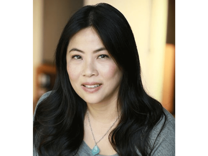Headshot of Karen Yin. She wears a pendant necklace and a grey sweater.
