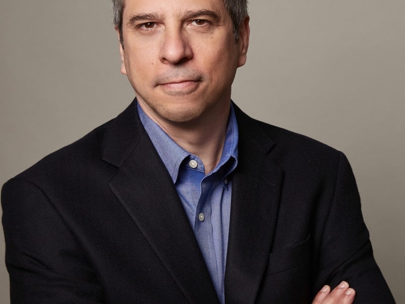Steven Waldman, a white man with graying brown hair, looks into the camera with a neutral expression.