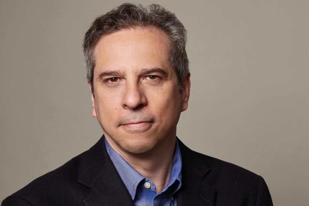 Steven Waldman, a white man with graying brown hair, looks into the camera with a neutral expression.