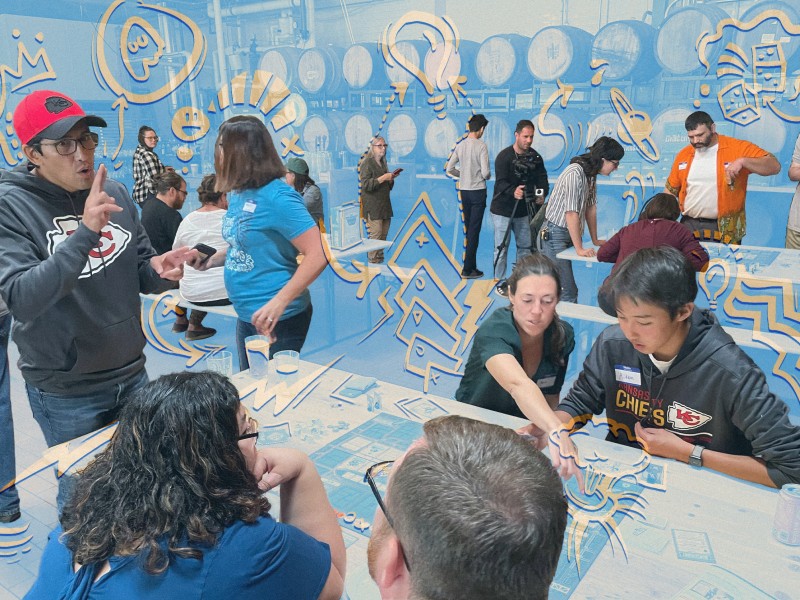 A diverse group of people of varying ages, races and genders sit at tables in a gathering space engaged in conversation at a CivicLex-hosted event. A light blue overlay is fixed over the picture with orange accents around the people.