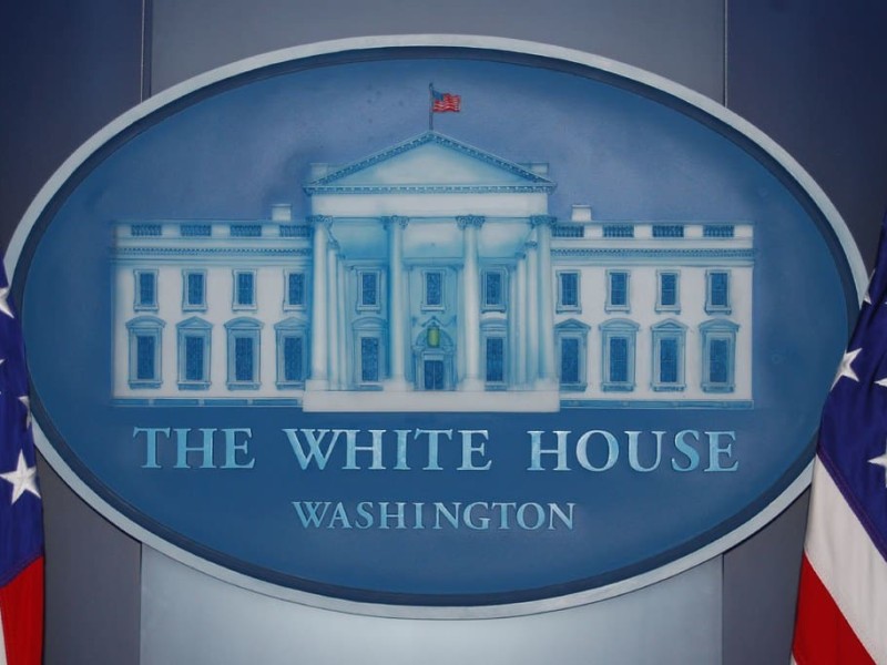 A close-up of the White House signage in the White House press briefing room.
