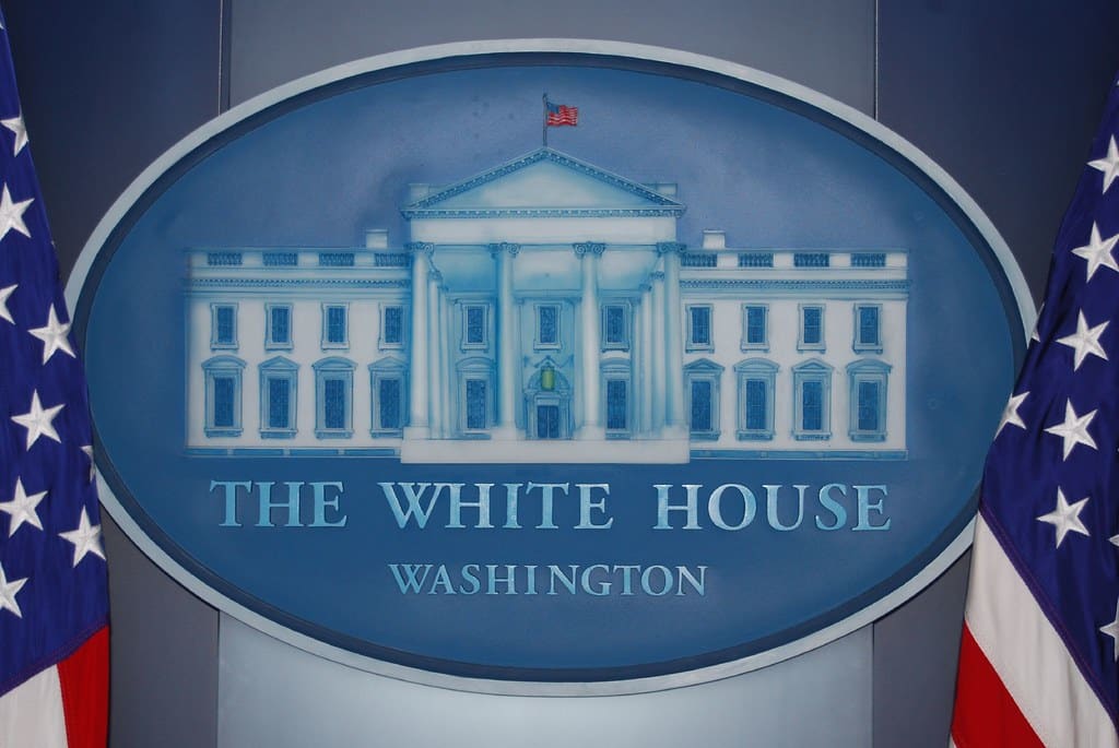 A close-up of the White House sign in the White House press briefing room.