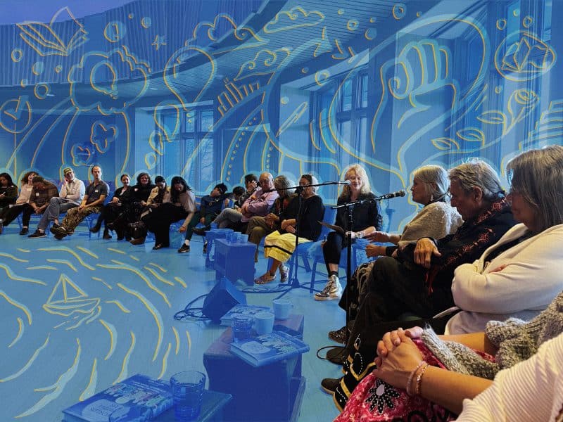Native and non-Native media practitioners sit in a circle discussing the roots of American democracy in Indigenous tradition. The image is stylized with a blue filter applied over all but the people, and iconography in light blue and orange outlines depicts a boat on a body of water, along with thought bubbles rising out of people's heads.